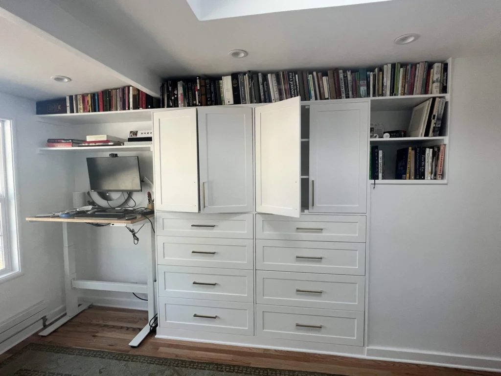 ADU: Garage turned ADU: white built-in cabinets, drawers and bookshelves beside a standing desk, Mill Valley