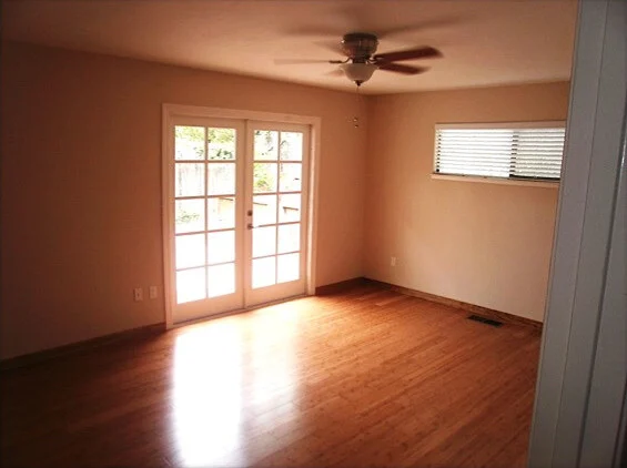 Flooring: Bedroom with new hardwood floor, white French doors and ceiling fan