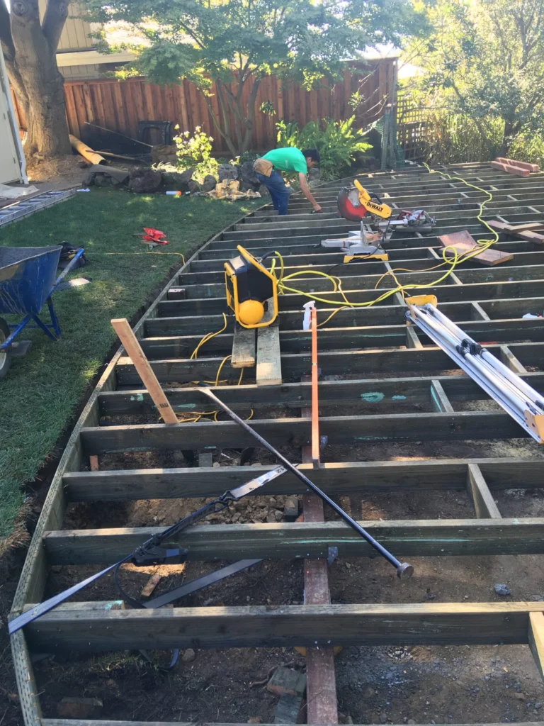 Deck: Curved deck joists going in on concrete piers, Peacock Gap, San Rafael