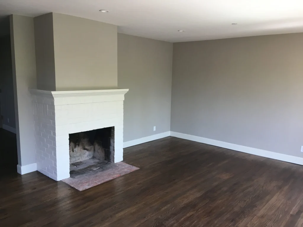 Flooring: Living room with white painted brick fireplace and dark hardwood, San Rafael duplex