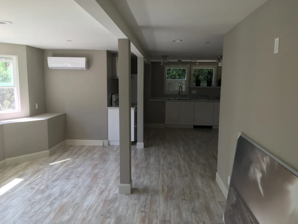Flooring: Open-plan lower unit with wood-look floor, mini-split and kitchen, San Rafael duplex