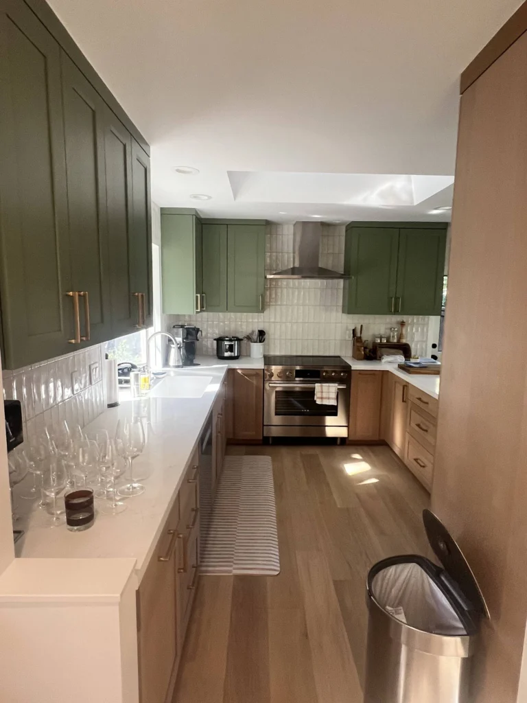 Kitchen remodel: Long view down the kitchen: green uppers, oak lowers and white quartz, Sleepy Hollow