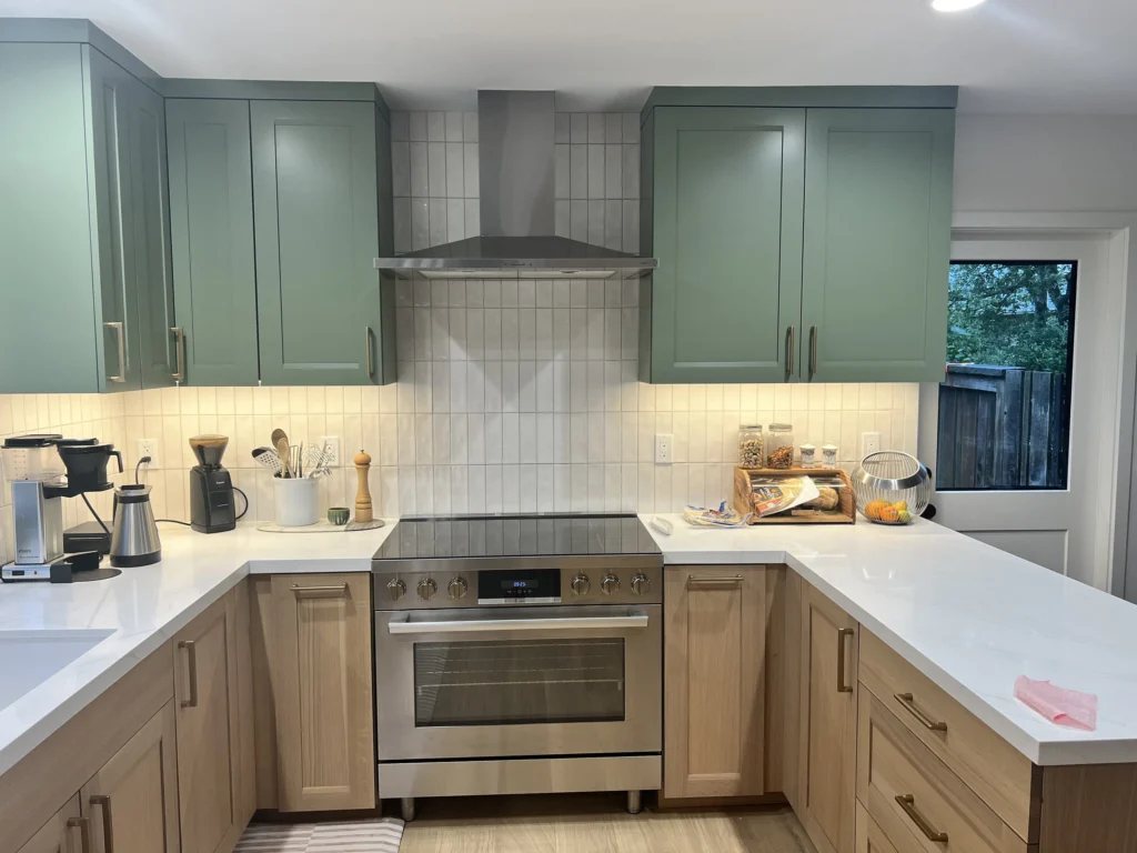Kitchen remodel: Range wall with sage green cabinets, white tile backsplash and stainless hood, Sleepy Hollow