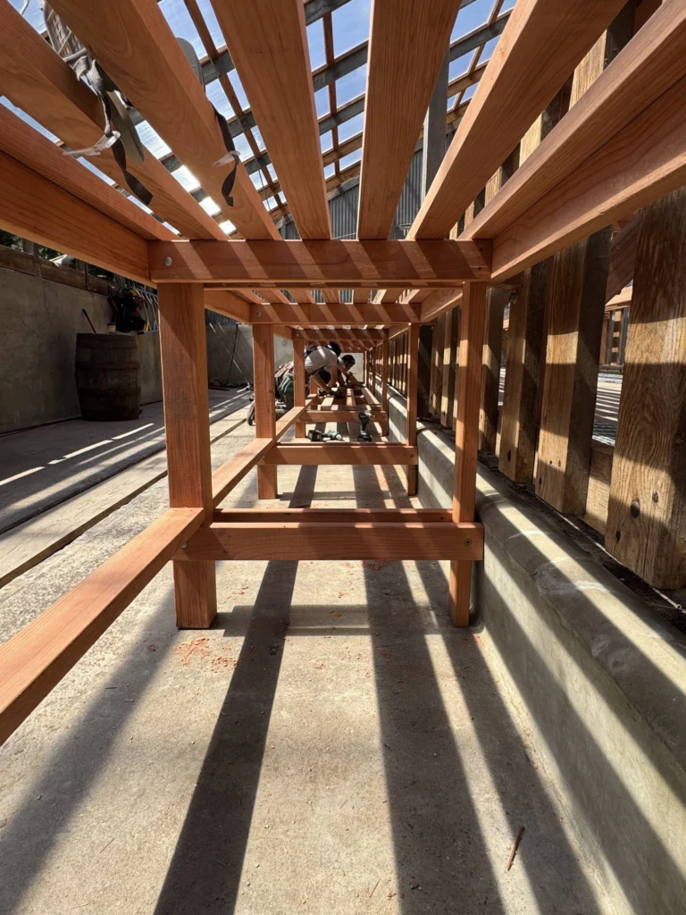 Whole-house remodel: Redwood greenhouse bench frame, looking down its length, Bolinas