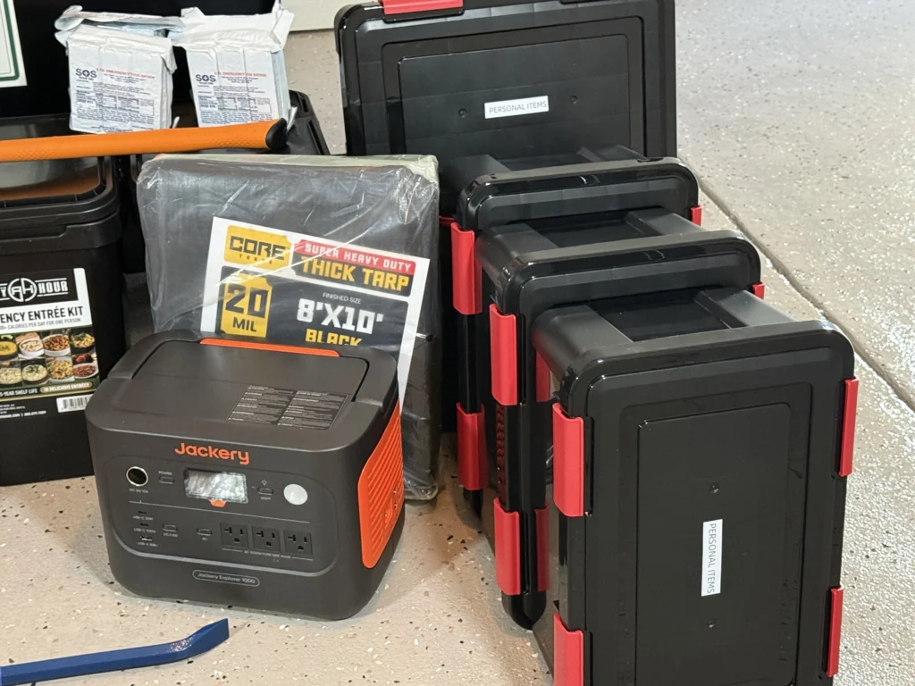 Close up of the cache contents: a portable power station, food buckets and supply cases