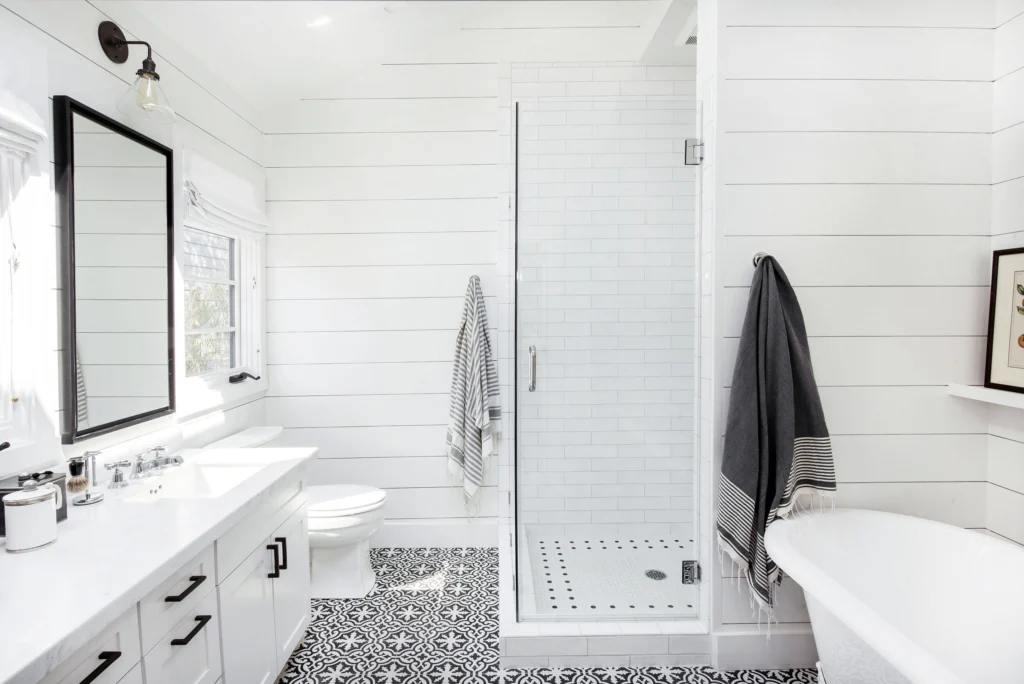 Bathroom remodel: Shiplap bathroom with subway-tile shower, black and white cement tile floor and freestanding tub
