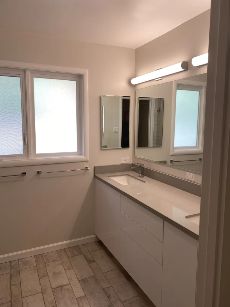 Bathroom remodel: Long white double vanity with quartz top and grey plank tile floor, Tiburon