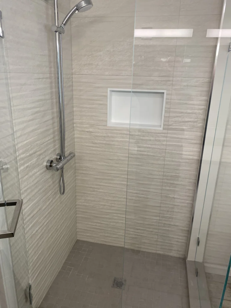 Bathroom remodel: Shower with textured tile, niche and slide-bar shower head, Tiburon