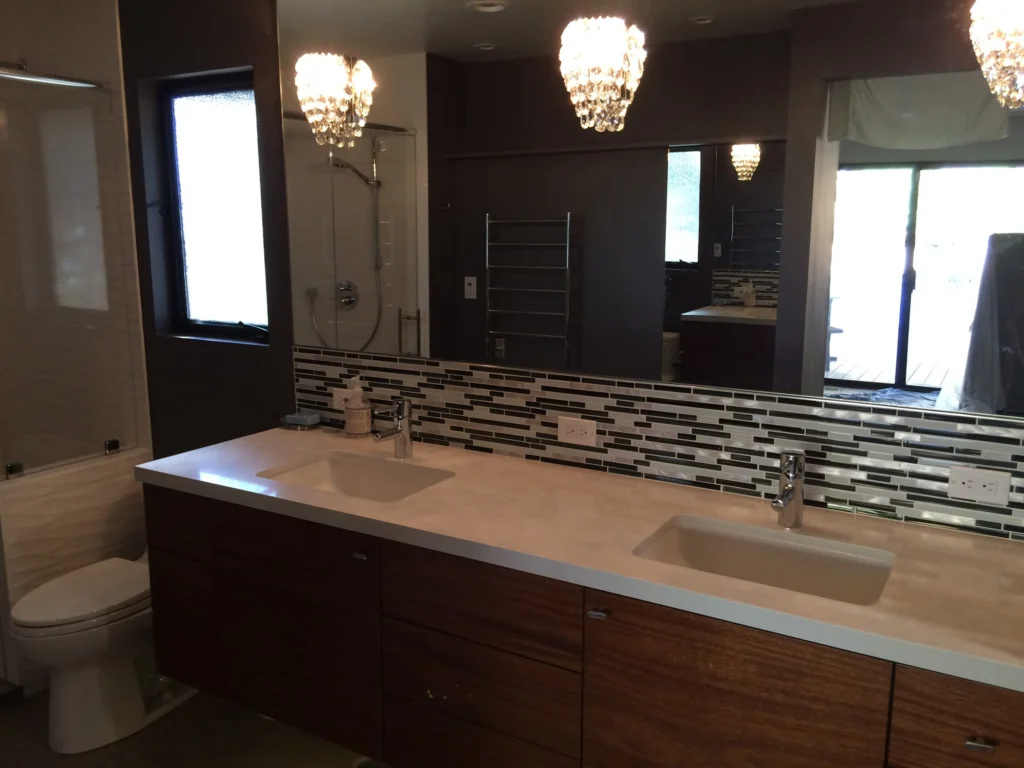 Bathroom remodel: Floating walnut double vanity with glass mosaic backsplash and chandeliers, Terra Linda